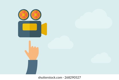 A hand pointing to video cam icon. A contemporary style with pastel palette, light blue cloudy sky background. Vector flat design illustration. Horizontal layout with text space on right part.