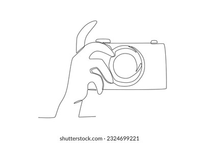 A hand prepares to take pictures. World photography day one-line drawing