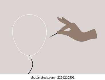 Hand pricking a transparent balloon with a needle