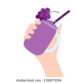 Hand is holding​ a purple smoothie juice in a glass cup with and has grape on top. A cold soft drink for summer. Healthy beverage. Tasty and yummy food. A takeaway Product advertisement.