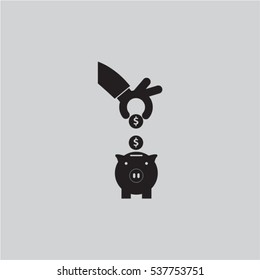 Hand put down coin into pig bank