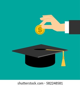 hand put gold coin in graduation cap.