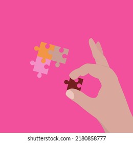 Hand put missing piece of jigsaw puzzle.