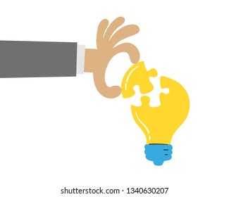 Hand put a part of light bulb puzzle, idea concept