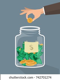 Hand putting coin in jar