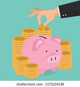 Hand putting coin a Piggy bank money savings concept 