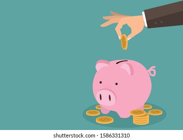 Hand putting gold coin a Piggy bank money savings concept 