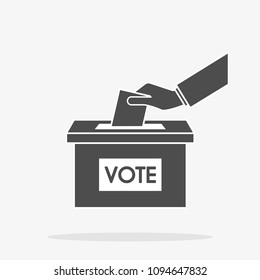 Hand putting paper in the ballot box. Voting concept.