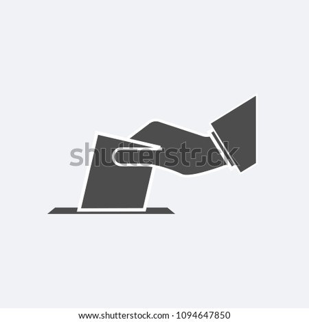 Hand putting paper in the ballot box. Voting concept.