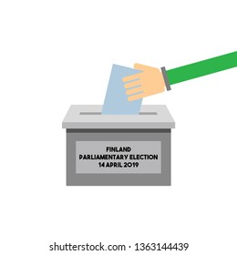 Hand putting a voting ballot in a slot of box in parliamentary election of Finland on 14. april 2019