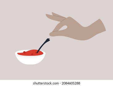 Hand reaching to a bowl of raspberry jam, breakfast traditional food
