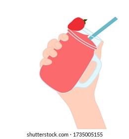 Hand is holding​ a red smoothie in a glass cup with and has strawberry on top. A cold soft drink for summer. Sweet beverage. Tasty and yummy food. A takeaway Product logo or advertisement.