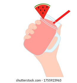 Hand is holding​ a red smoothie in a glass cup with and has watermelon slice on top. A cold soft drink for summer. Sweet beverage. Tasty and yummy food. A takeaway Product logo or advertisement.