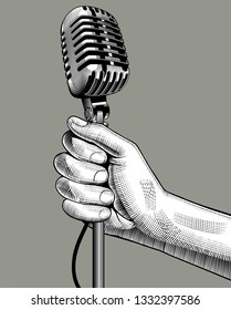 Hand with a retro microphone. Vintage engraving stylized drawing. Vector illustration