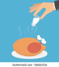 Hand salting a roasted chicken