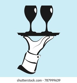 Waiter’s hand serving two glasses of wine.