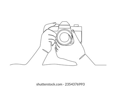 A hand set the focus of a digital camera. World photography day one-line drawing