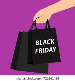 In the hand, shopping bags with the inscription black Friday on a violet background. Vector illustration.