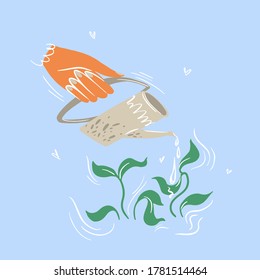 Hand with a small beige watering can watering young greens