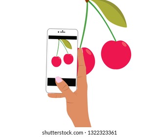 the hand takes photo of cherries