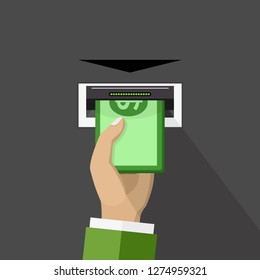Hand taking cash from ATM