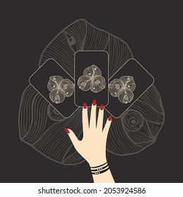Hand with tarot cards, a layout of cards on the table, hand drawing an esoteric flower on the back of cards, mysticism, magic, esotericism.