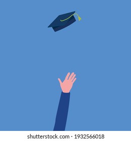 hand that just threw mortarboard on blue background
