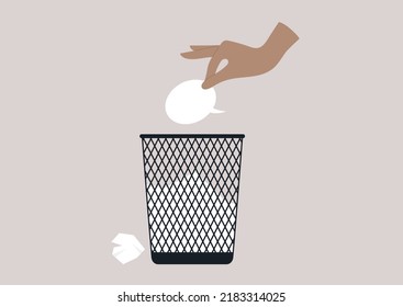 A hand throwing a speech bubble in a waste bin, a censorship concept