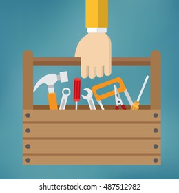 Hand with toolbox on the blue background.