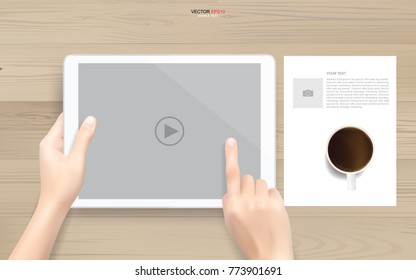 Hand touch screen digital tablet with video player symbol on wood background. Vector illustration.