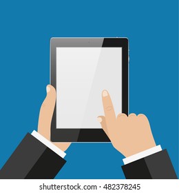 Hand touching screen of black tablet computer