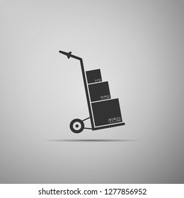 Hand truck and boxes icon isolated on grey background. Dolly symbol. Flat design. Vector Illustration