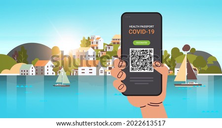 hand using digital immunity passport with qr code on smartphone screen risk free covid-19 pandemic