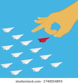 The hand is using the finger to strum the leader of the paper plane.