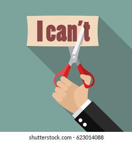 Hand using scissors to remove the word can't to read I can. Self belief concept