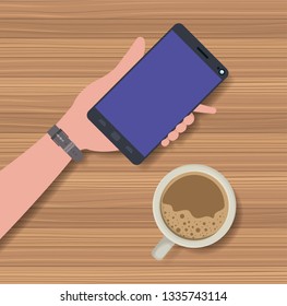 hand using smartphone with coffee cup in the table