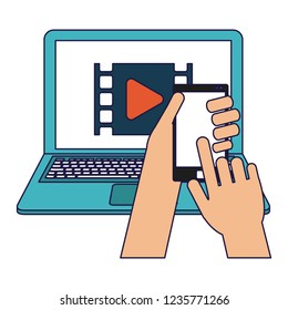 Hand using smartphone and laptop
