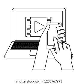 Hand using smartphone and laptop black and white