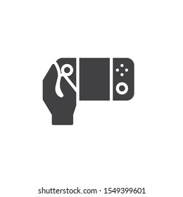 Hand with Video game console vector icon. filled flat sign for mobile concept and web design. Using portable game pad glyph icon. Symbol, logo illustration. Vector graphics
