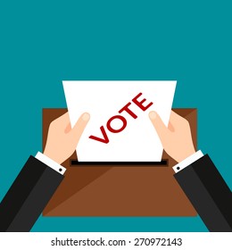 Hand with voting ballot and box