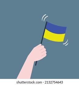 Hand waving Ukraine flag; support Ukraine concept