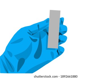 A hand wearing blue glove while holding a small object.