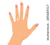Hand wearing engagement ring and wedding ring.