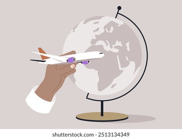 A hand, wearing a white sleeve, holds a white toy airplane with purple engines, prepared to launch it into the air around the globe