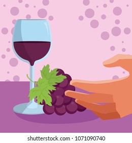 Hand with wine cup and grapes