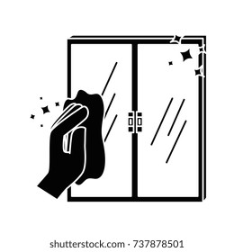 hand wiping window with cloth