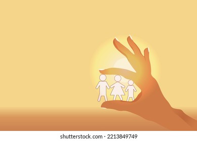 Hand Of Woman Hold A Small Model Of A Family On The Sunrise Background With Copy Space. Concept Of Life Insurance. Health And Medical Insurance Of People.