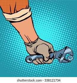 Hand and working the wrench pop art retro style