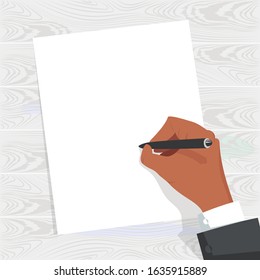 the hand writes. blank form. a person writes a letter. hand on the table. wooden background