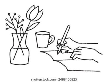 A hand writing something in a notebook and a vase